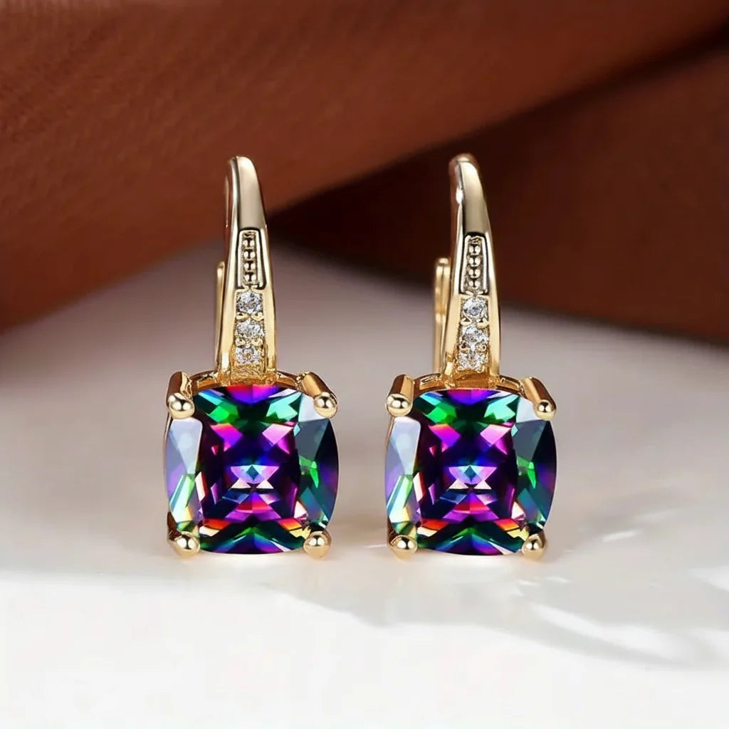 Claudine – Aros dorados con zafiro místico