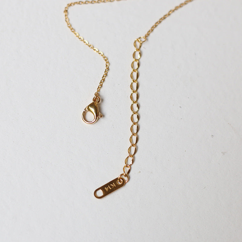 Nelly – Collar cruz minimalista en dorado