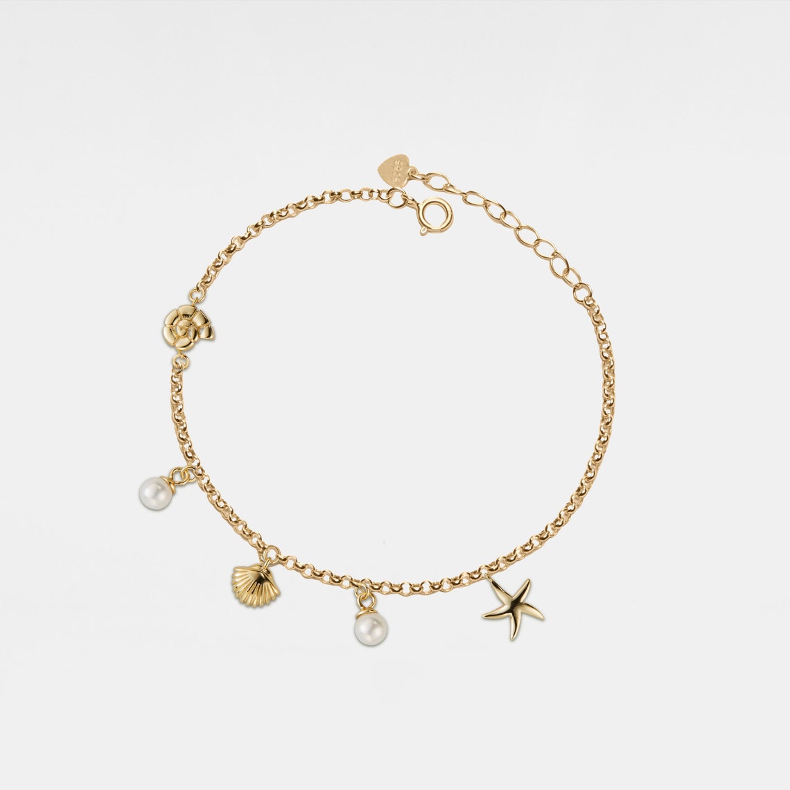 Pulsera con colgante de concha y estrella de mar